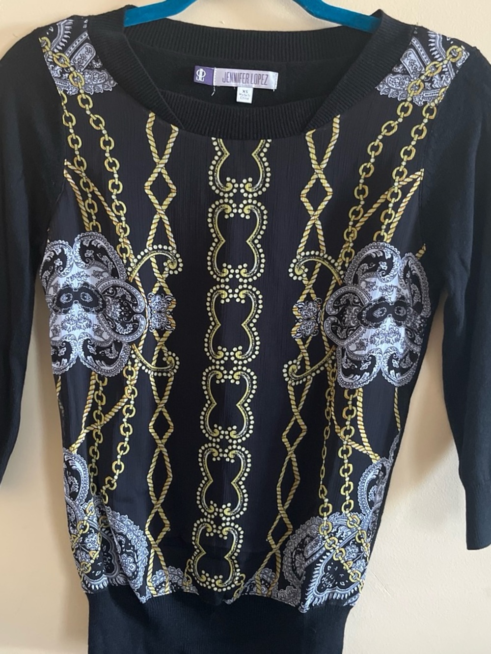 Jennifer Lopez Black Sweater with Gold Chain & White Paisley Medallions